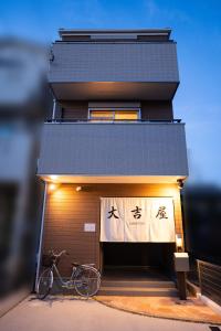 un vélo garé devant un bâtiment dans l'établissement 大吉屋日赤館貸切一軒家旅館新築名古屋駅圏内, à Nagoya