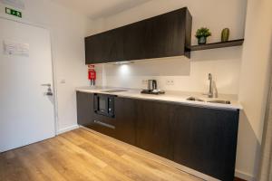 a kitchen with a sink and a counter top at Watts House in Seia