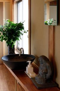 a bathroom with a black sink and a plant at Kungin Bettei - Vacation STAY 14605 in Himeji