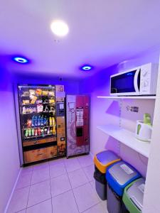 a purple room with a vending machine with drinks at Alcorso Pension in Banská Bystrica