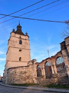 an old building with a tower on the side of it at Luxury Live in Kamianets-Podilskyi