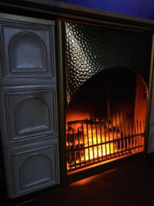 a fireplace with a fire inside of it at Blue Royal Apartment in Celle