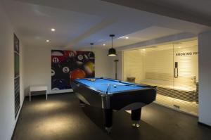 a billiard room with a pool table in it at The President Hotel in Hubli