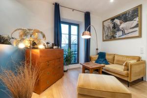 a living room with a couch and a dresser at Escale Rochelaise, chambre avec acces toute l'année au sauna et SPA chauffée in La Rochelle