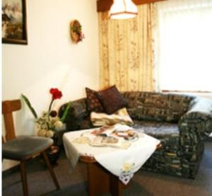 a living room with a couch and a table at Haus Bergkristall in Längenfeld