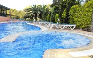 a large blue pool with tables and chairs in it at Aparthotel SunClub Salou in Salou