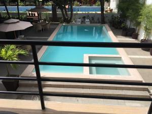 a large blue swimming pool in a building at Hotel Carmelita in Tuguegarao City