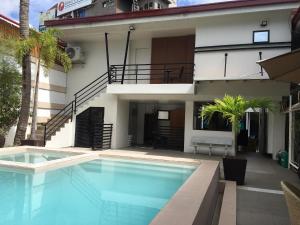 a swimming pool in front of a building at Hotel Carmelita in Tuguegarao City