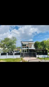 a large building with a tennis court in front of it at Al Hidayah Suite in Bandar Seri Begawan