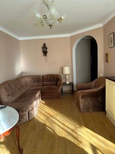 a living room with two couches and a ceiling fan at Rest house in Truskavets