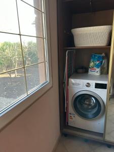 a washing machine in a room with a window at Rest house in Truskavets