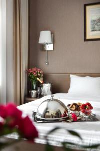 a tray of food on a bed in a hotel room at Alexandrovskiy Hotel in Odesa