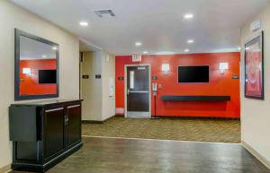 a lobby with red walls and a hallway with elevators at Extended Stay America Suites - Phoenix - Airport in Phoenix