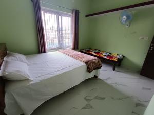 Un dormitorio con una cama grande y una ventana en Sili Homestay, en Madikeri