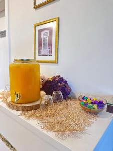 a table with a yellow cake and glasses on it at Hotel Don Rodrigues in Tavira