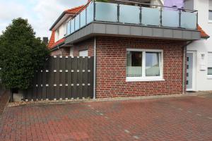 una casa in mattoni con balcone sopra di Ferienwohnung "TimeOut" a Hage