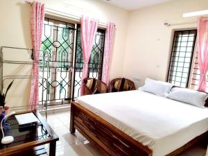 Krevet ili kreveti u jedinici u objektu GREENVIEW HOMESTAY KOVALAM