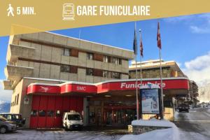 a building with a car parked in front of it at Plein Ciel I Balcony I Close to cable cars I Car park in Crans-Montana