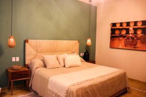 Giường trong phòng chung tại Hotel Boutique Gloriagave