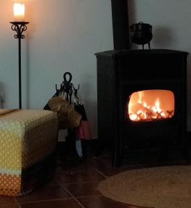 a fireplace in a room with a fire in it at Casa da Muralha in Estremoz