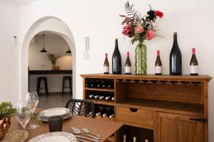 a dining room with a table with wine bottles at VILLA WINE & BEACH Design and Luxury in Cala Crancs in Salou