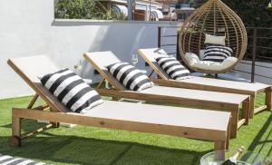 two chairs and a swing on a patio at VILLA WINE & BEACH Design and Luxury in Cala Crancs in Salou