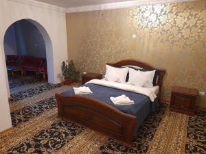 a bedroom with a bed with two towels on it at Pensiunea Crown Royal in Alba Iulia