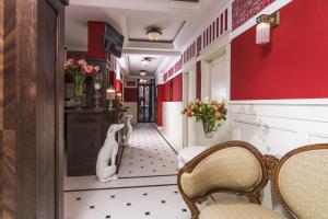 a hallway with chairs and a red wall at Villa Mozart in Truskavets