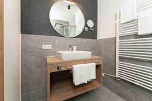 a bathroom with a sink and a mirror at A CASA Serenity in Serfaus