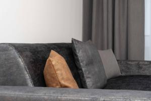 a gray couch with two pillows on it at A CASA Serenity in Serfaus