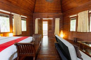 A bed or beds in a room at RedDoorz Resort @ Taman Wisata Mangrove