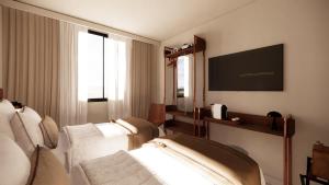 a hotel room with a couch and a flat screen tv at Adonis le Castellet in Signes