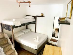 A bed or beds in a room at Pachamama Hostel Cartagena