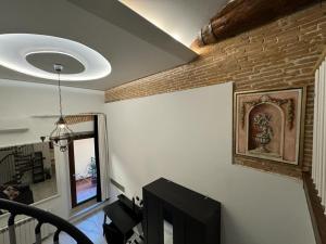 un soggiorno con TV e muro di mattoni di Venus Two-Floored Stylish Apartment in the City Center a Firenze