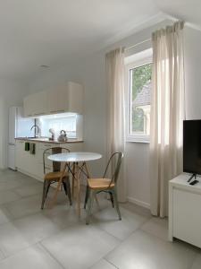 a kitchen with a table and chairs and a window at The View 22 in Cerklje na Gorenjskem