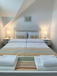 a bedroom with a large bed with two lamps at The View 22 in Cerklje na Gorenjskem