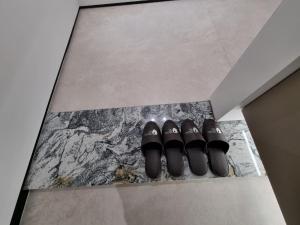 two pairs of shoes sitting on a floor at HOTEL THE DESIGNERS LYJ SUITE YEOKSAM in Seoul