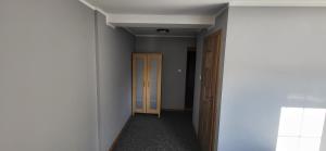 an empty hallway with two doors in a room at Willa Nad Białką in Białka Tatrzanska