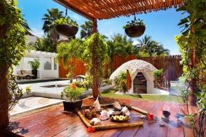 a backyard with a wooden deck with a gazebo at El Dorado Casitas Royale Catamarán, Cenote & More Inclusive in Puerto Morelos