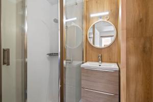 a bathroom with a sink and a mirror at Smartstay Altineige - Val Thorens in Val Thorens