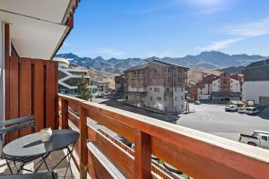 a balcony with a table and a view of a street at Smartstay Altineige - Val Thorens in Val Thorens