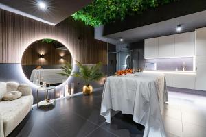 a living room with a table and a kitchen at Aparthotel Diamond SPA Aqua in Białka Tatrzanska