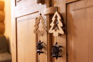 a group of wooden christmas ornaments hanging on a door at Chambres d'hôtes Les Rondins De La Fecht in Mittlach