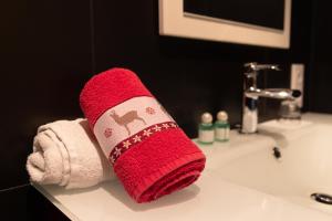 a red sock sitting on top of a bathroom sink at Chambres d'hôtes Les Rondins De La Fecht in Mittlach