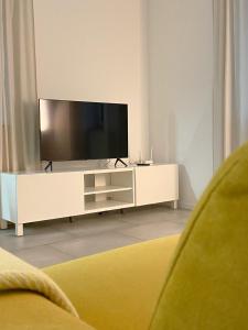 a living room with a television on a white entertainment center at The View 22 in Cerklje na Gorenjskem