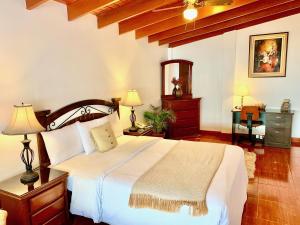 A bed or beds in a room at Casa Bella Boutique Hotel San Isidro