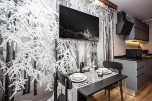 a dining room with a table and a wall covered in snow at DEER LODGE in Breuil-Cervinia