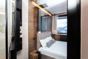 a small bedroom with a bed and a window at DEER LODGE in Breuil-Cervinia