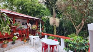 a porch of a house with a table and chairs at Hotel Casa Quinta Salento in Salento