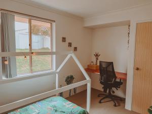 a bedroom with a bed and a desk and a chair at BEACH 400m, Big Yard, Playroom, Perfect for Families, Couples, Digital Nomads in Mandurah